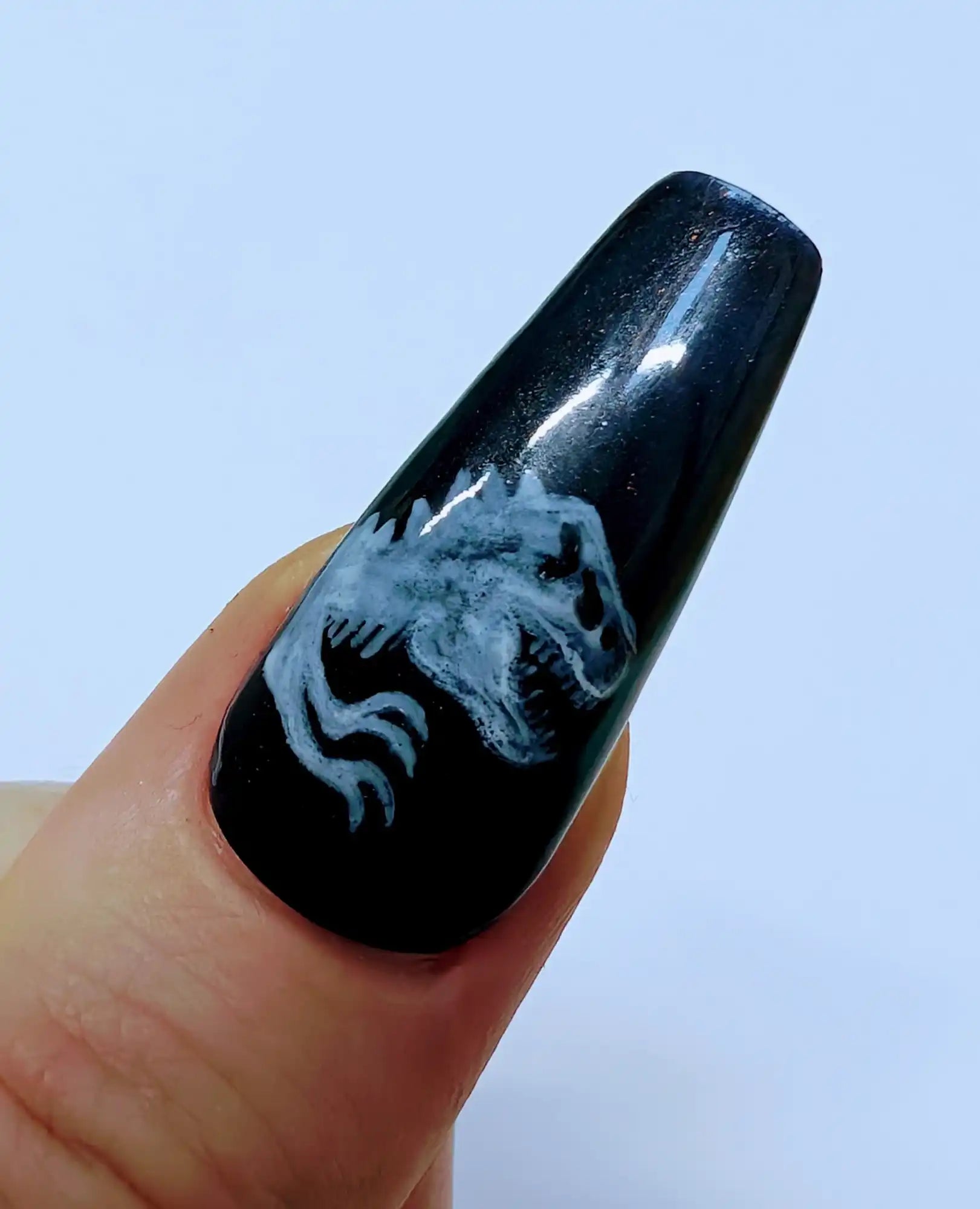 Black nail with dinosaur design.